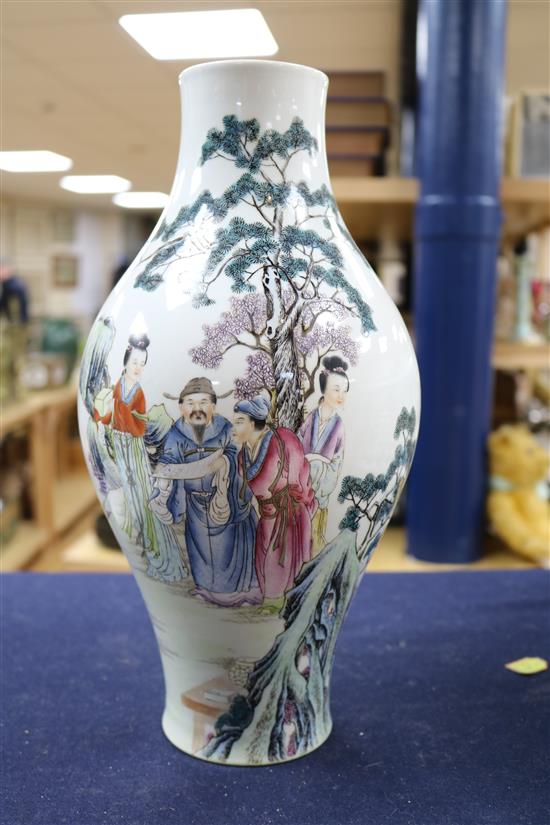 A Chinese famille rose baluster shaped vase, 20th century, height 33cm, wood stand